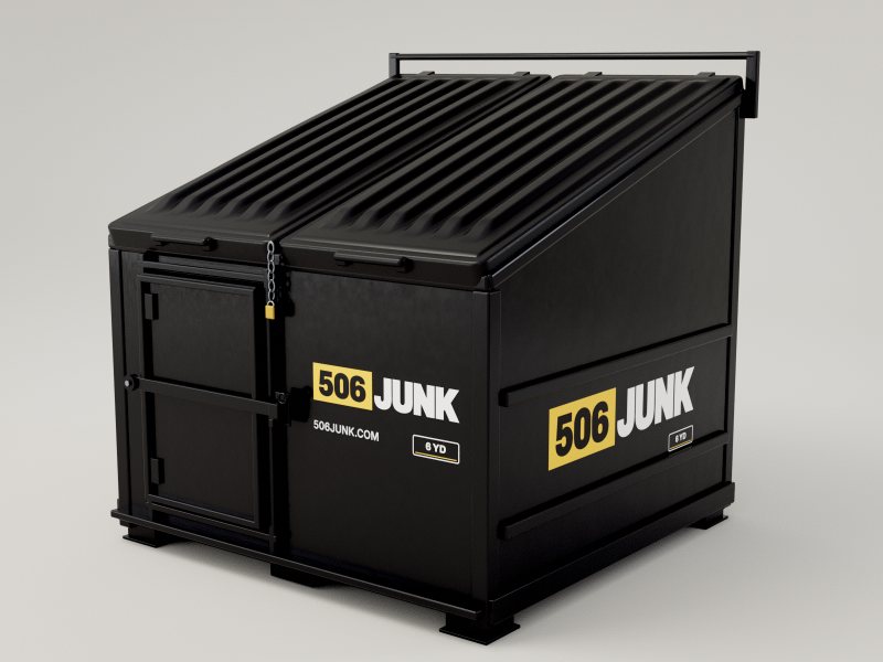 Black 506 Junk 6-yard slant-top bin with a sloped lid and front crew door